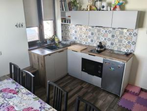 a small kitchen with white cabinets and a table at Widlakówka in Rzepiska +26 photos