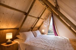 a bedroom in an attic with a bed and a window at Luna Inn B&B in Corfu