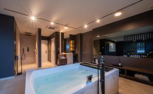a large bathroom with a large bath tub at Loft La Suite et sa Suite in Thimister +119 photos