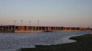 a large building next to a body of water at Lomas de San Vicente Hotel Boutique in Balneario Buenos Aires