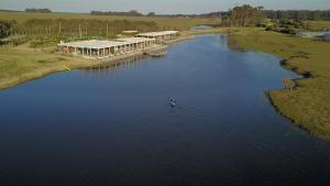 a person is in a boat on a river at Lomas de San Vicente Hotel Boutique in Balneario Buenos Aires
