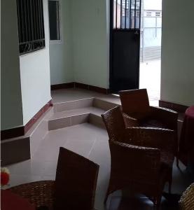 a room with two chairs and a table and a window at Mkula Executive Lodge in Mugumu