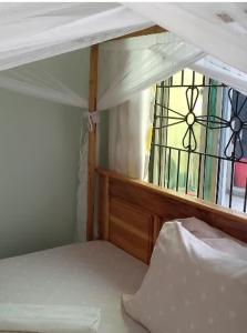 a bunk bed with a view of a stained glass window at Mkula Executive Lodge in Mugumu