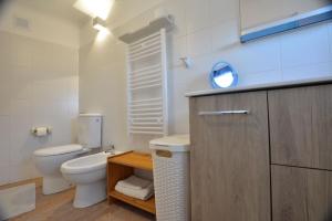 a bathroom with a toilet and a sink and a mirror at Casinha in Sintra +9 photos