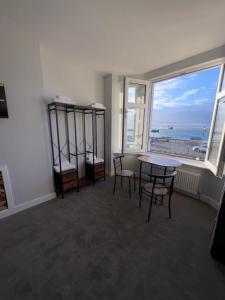 a room with a table and chairs and a large window at Skips in Largs