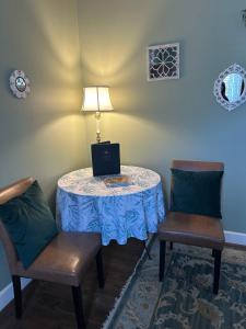 a table with a laptop on it with two chairs at Barksdale House Inn in Charleston +58 photos