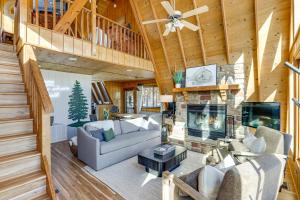 a living room with a couch and a fireplace at Hot Tub & Barrel Sauna: Lakefront Innsbrook Chalet in Wright City