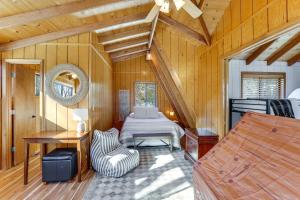 a room with a bed in a wooden cabin at Hot Tub & Barrel Sauna: Lakefront Innsbrook Chalet in Wright City +37 photos