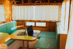a laptop computer sitting on a table in a train room at Hotel Luna Mystica in Taos