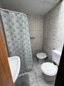 a bathroom with two toilets and a shower curtain at Elvira in Estación Circunvalación