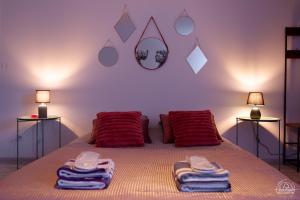 a bedroom with a bed with towels on it at Le Cocon Love Room & Spa in Nancy
