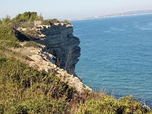 a cliff next to the ocean with a fence at Chez Jacques in Port-la-Nouvelle +2 photos