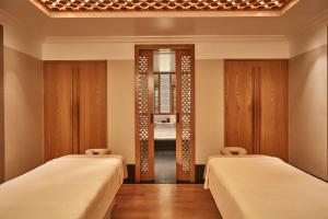 a room with two beds and a mirror at The Connaught, Maybourne in London +77 photos