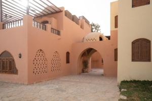 an external view of a building with doors and a courtyard at The Downtown Getaway Studio in Hurghada