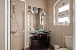 a bathroom with a glass sink and a shower at The Downtown Getaway Studio in Hurghada
