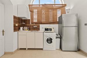 a kitchen with a refrigerator and a washing machine at The Downtown Getaway Studio in Hurghada
