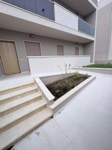 a house with stairs in front of it at Oltre Le Onde in Nova Siri Marina