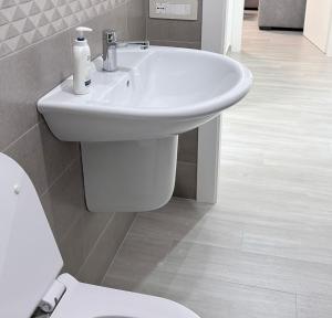 a bathroom with a white sink and a toilet at Oltre Le Onde in Nova Siri Marina +10 photos
