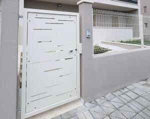 a white door in front of a building at Oltre Le Onde in Nova Siri Marina