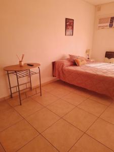 a room with two beds and a table in it at Bahia Rental 11-Departamento x dia con cochera in Bahía Blanca +1 photo