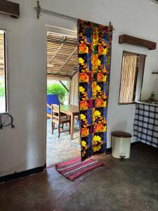 an open door to a room with a table at Maison Baby plein centre in Ambatoloaka
