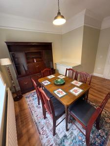 a dining room with a wooden table and chairs at Cosy Townhouse 2bedroom in Enniscorthy