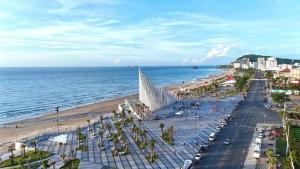 a view of a beach with the ocean and buildings at The Sóng Vung Tau Apartment - Pool Near Sea in Vung Tau