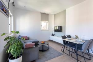 a living room with a couch and a table at Apartments Jakic 1 in Hvar