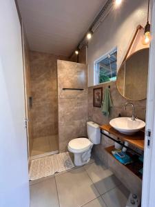 a bathroom with a shower and a toilet and a sink at Nonna Paulina in Timbó +31 photos