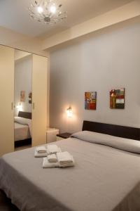 a bedroom with a large bed with towels on it at Asaro Camere in Campobello di Licata