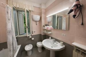 a bathroom with a sink and a toilet and a mirror at Il Tulipano Camera con bagno privato a Marcianise in Marcianise +3 photos
