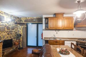 a kitchen with a couch and a table in a room at Casa da Ramada in Campo do Gerês