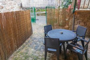 a table and chairs sitting next to a fence at Casa da Ramada in Campo do Gerês