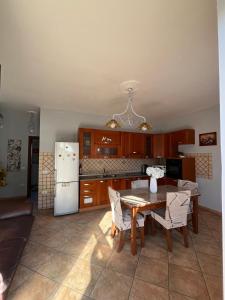 a kitchen with a table and a refrigerator at Bed and Breakfast Medaglia D'oro in Marcianise