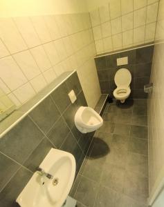 a bathroom with two toilets and a sink at 1 bedroom apartment 2 guests in Aschaffenburg