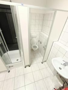 a bathroom with a toilet and a sink at 1 bedroom apartment 2 guests in Aschaffenburg