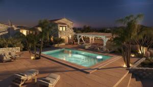 a swimming pool in front of a house at Villa Oasis 3 in Kalithies
