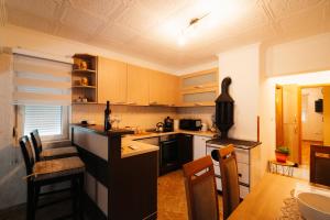 a kitchen with wooden cabinets and a table with chairs at Grahovo Lake in Čelina