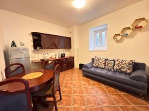 a living room with a couch and a table at Villa Kamena in Kotor
