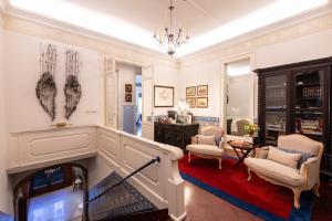 a living room with a fireplace and a chandelier at Casa de Sao Mamede Hotel in Lisbon