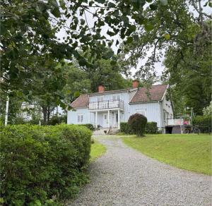 a white house with a gravel driveway at Safety System Show Jumps in Enköping