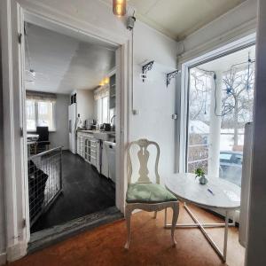 a kitchen with a table and a chair in a room at Safety System Show Jumps in Enköping