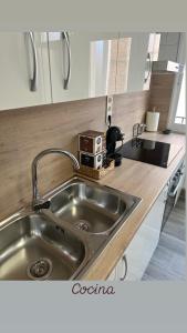 a kitchen with a sink and a counter top at Piso Moredas in Dúrcal +55 photos