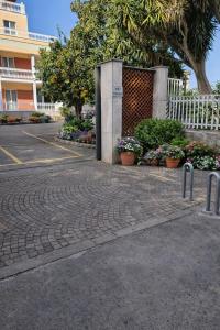 a brick road with plants and flowers in a parking lot at Sorrento life 3 in Sant'Agnello +41 photos