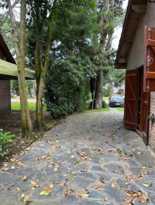 a driveway with leaves on the ground next to a house at OKIN 26 Unica in Costa del Este