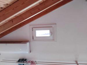 a small window in a room with a ceiling at Emerald Blue in Skiathos
