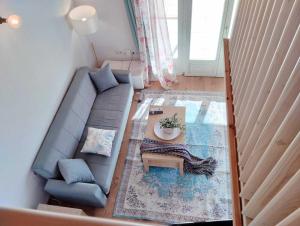 an overhead view of a living room with a couch and a table at Emerald Blue in Skiathos
