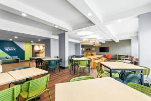an empty cafeteria with tables and chairs at Spark by Hilton Bardstown in Bardstown
