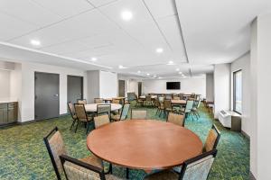 a conference room with tables and chairs and a podium at Spark by Hilton Bardstown in Bardstown +49 photos