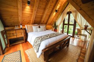 a bedroom with a bed in a wooden cabin at Hacienda Turistica Intihuatana in San Fernando +91 photos